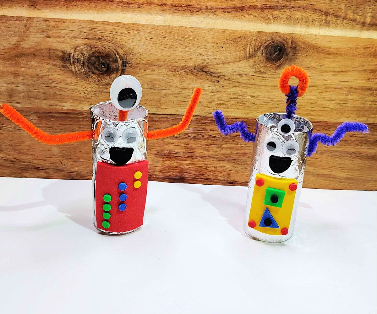Completed alien craft- two aliens red and yellow with arms, antennas, and googly eyes.- kids activities blog