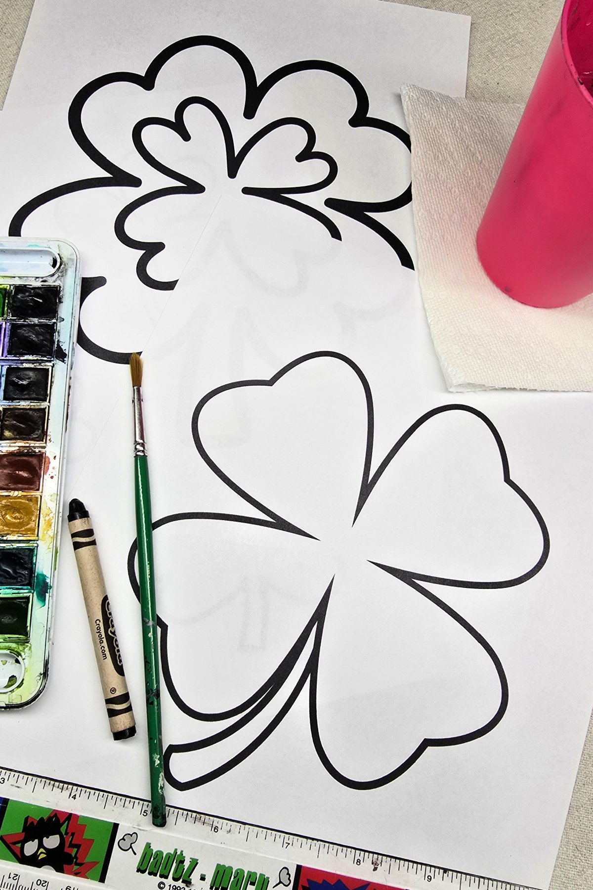 supplies needed for shamrocks and complementary colors includes free printable shamrock designs on cardstock, watercolor paints, black crayon, ruler, etc. kids activities blog
