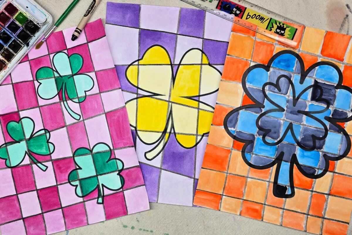 completed shamrock paintings using complementary colors, watercolors, and a black crayon. kids activities blog