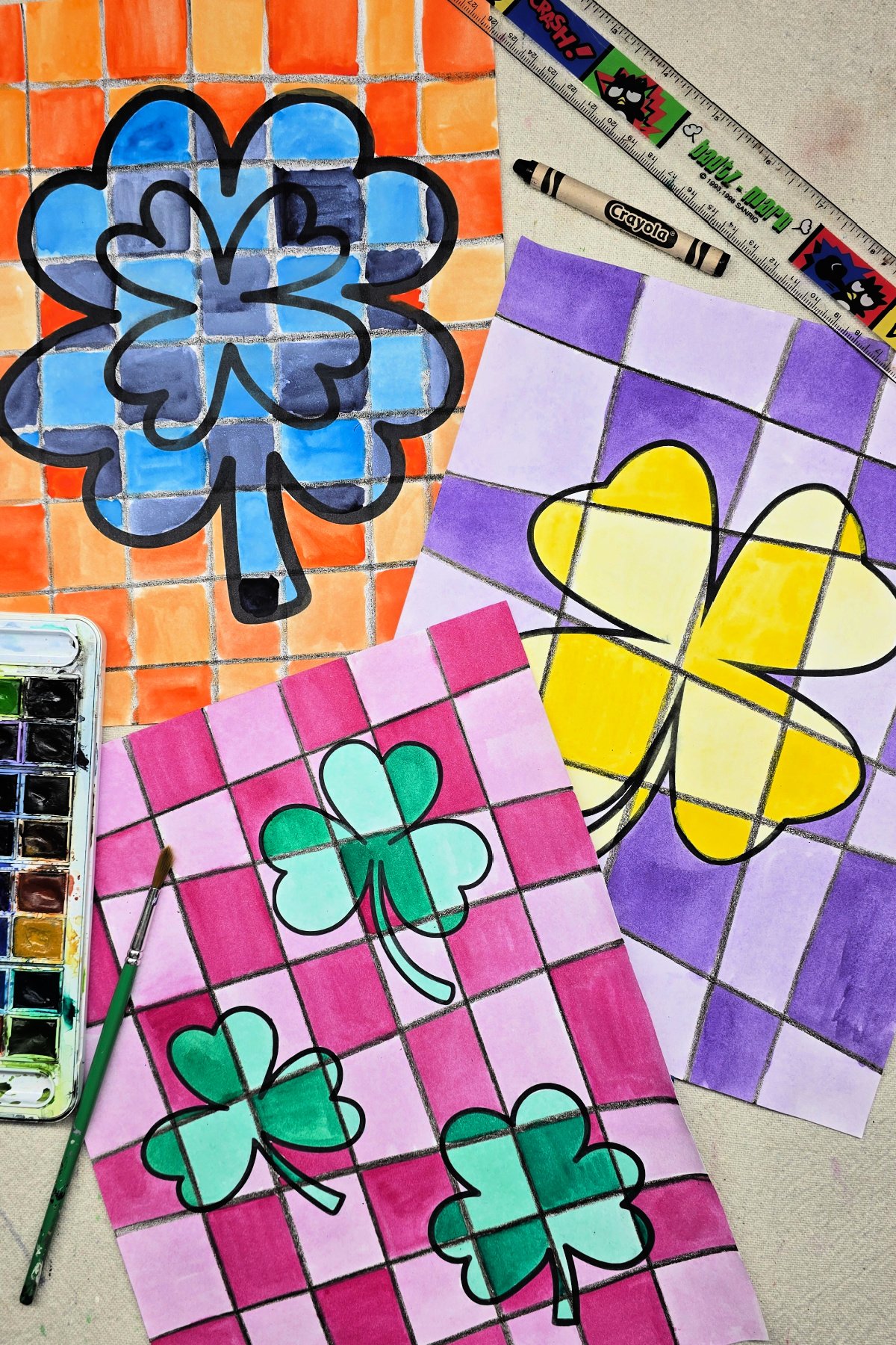 completed shamrock drawings using complementary colors, watercolors, and crayons - kids activities blog