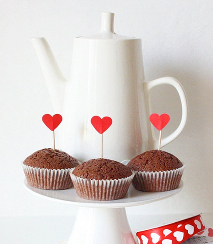 construction paper crafts for Valentines Day - top cupcakes with paper hearts made from construction paper shown here with chocolate muffins
