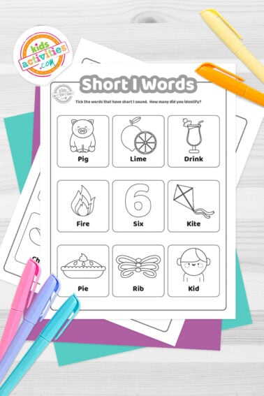 Black and white printed short I words worksheets on top of blue-green and purple sheets with assorted markers on a dark grey background. printed pdf version from Kids activities blog.