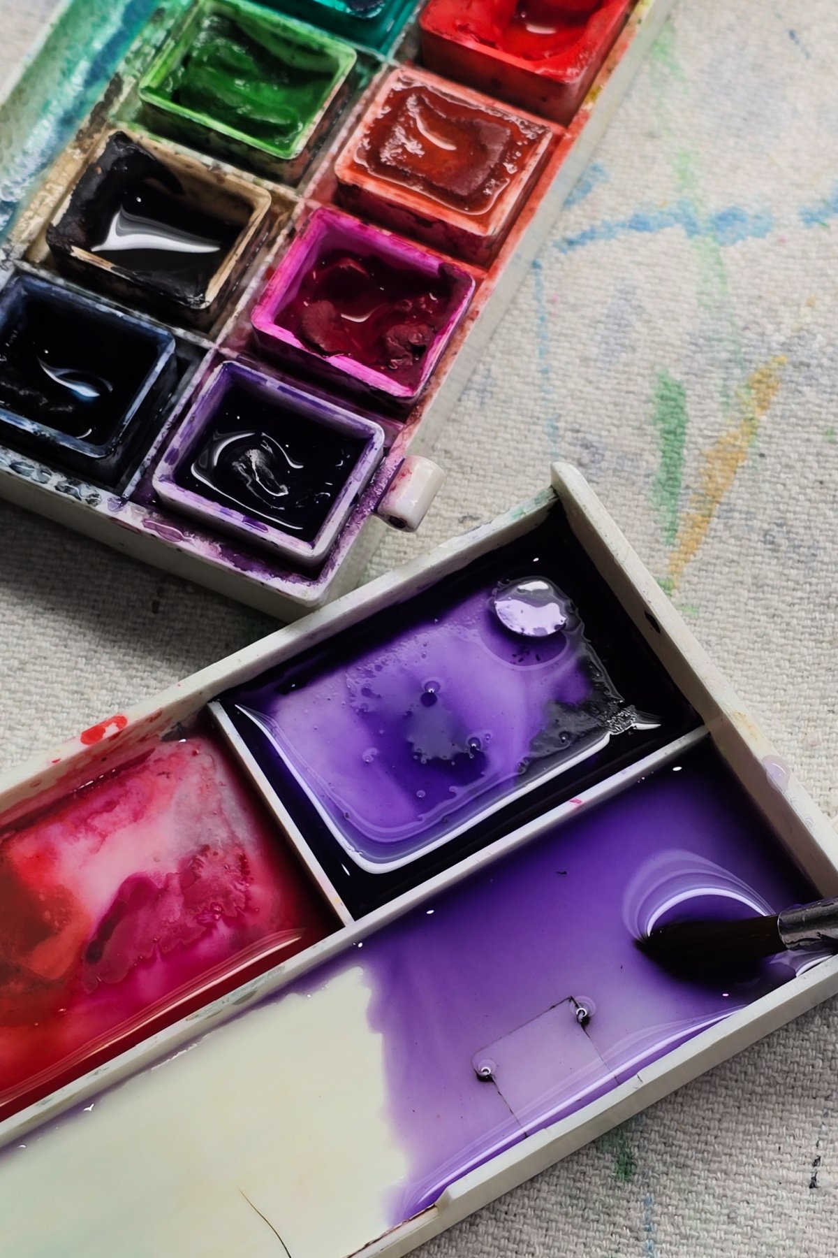 step 3 - adding water to purple paint paint to create a lighter value - kids activities blog