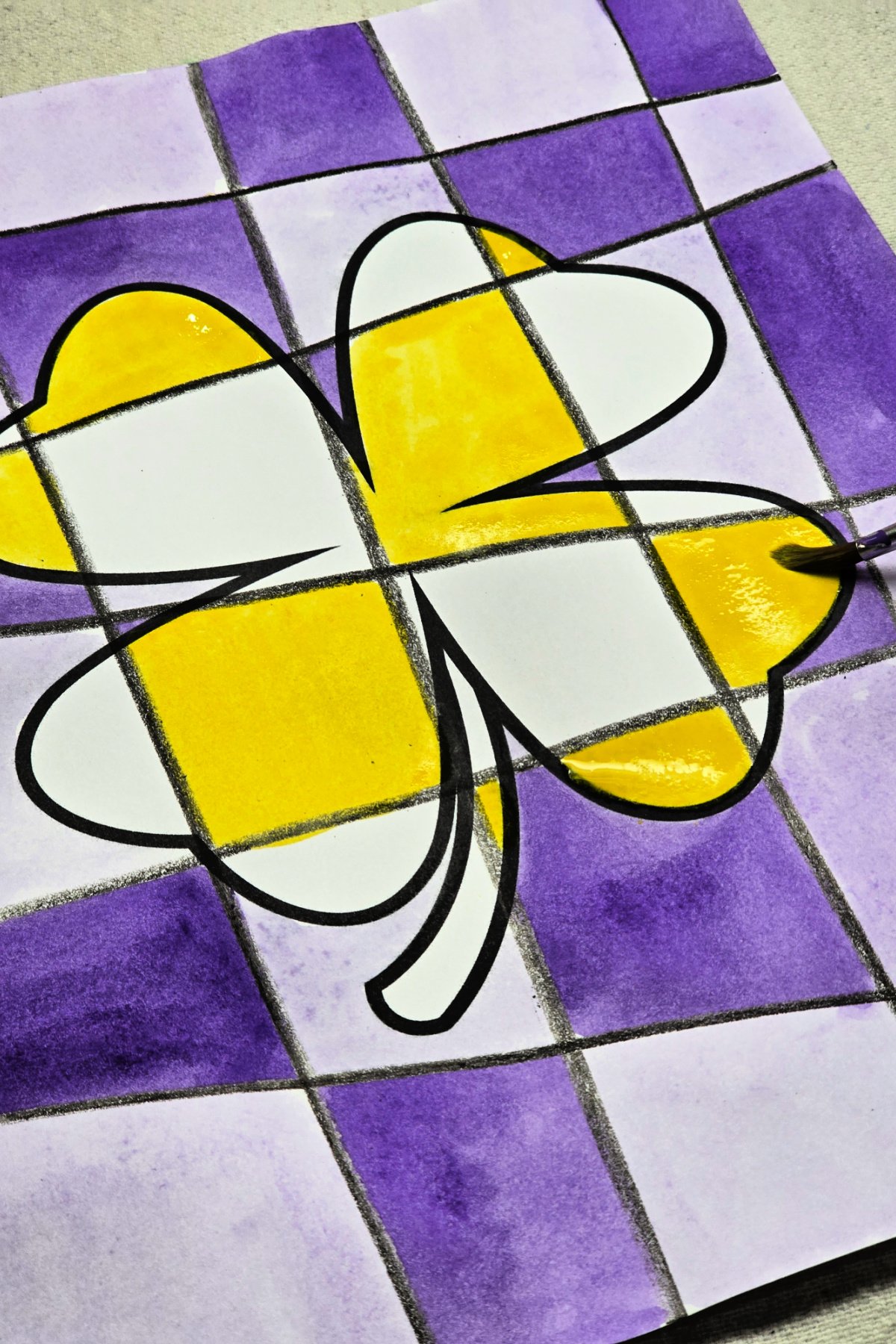 step 4 - painting every other square in the shamrock design with purple's complementary color, yellow. kids activities blog