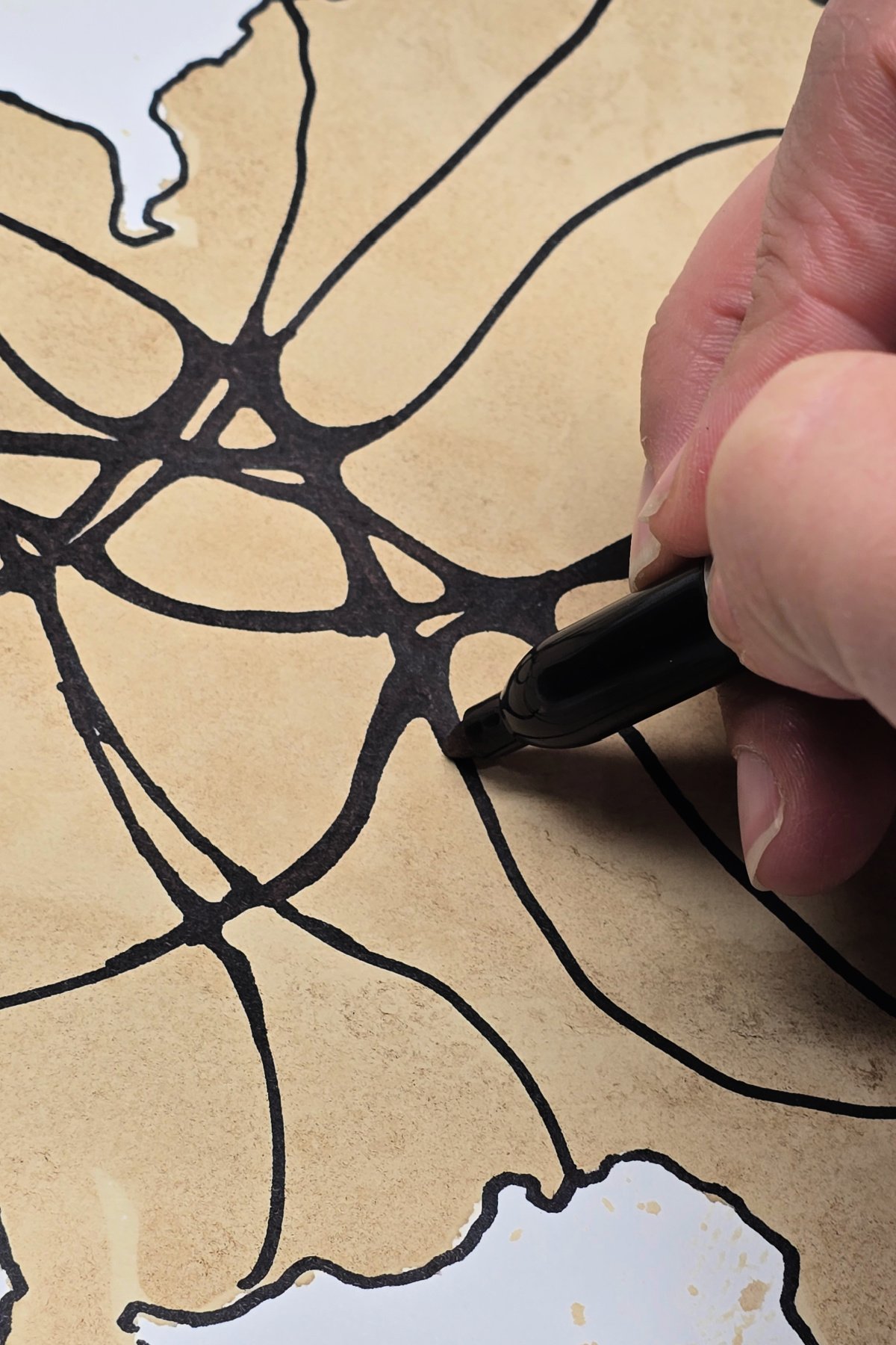 step 5 - using a permanent marker to round edges where wavy lines from previous step intersect. kids activities blog