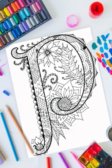 Zentangle alphabet coloring pages - letter p zentangle design on background of paint, colored pencils and art supplies