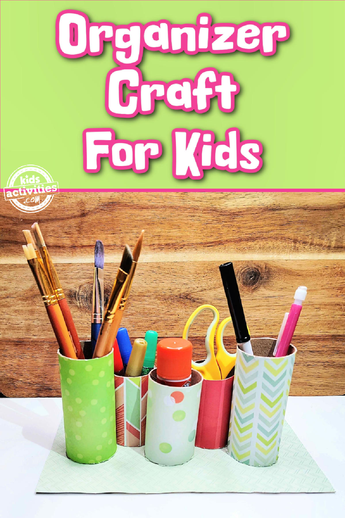 Toilet Paper Roll Craft- Art supply organizer with markers, pencils, paintbrushes, glue, glitter, and scissors against a wooden background with text- kids activities blog